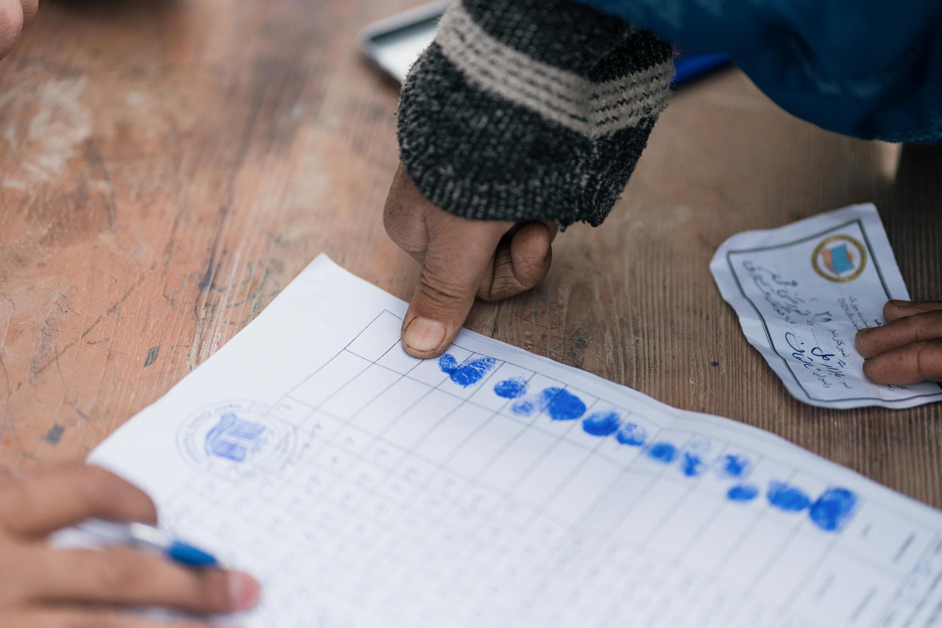 Close-up of fingerprint marking on a voting document in Afghanistan, showing election authentication.