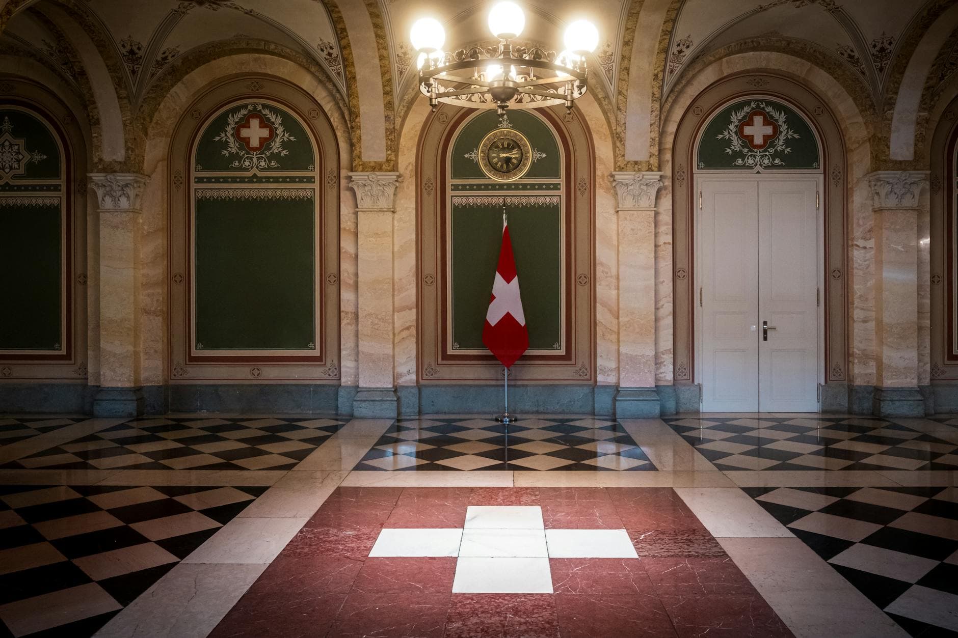 Elegant interior of the Swiss Parliament building in Bern, showcasing the Swiss flag.