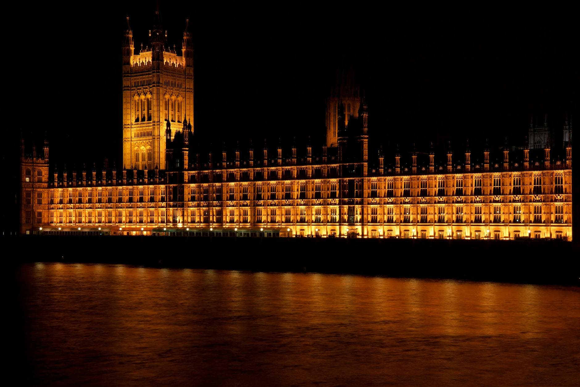 Stunning night view of Westminster Palace, London, reflected on the River Thames.